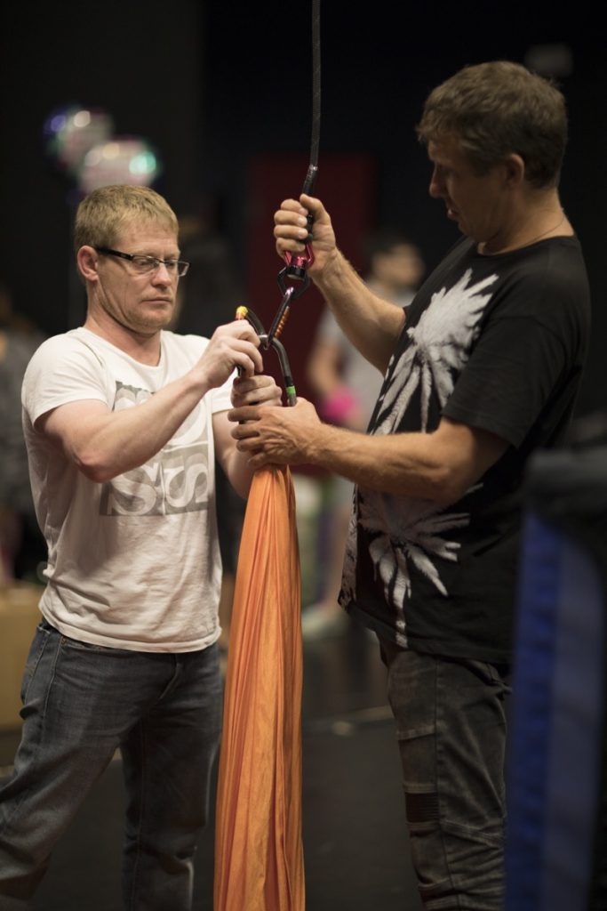 Orlando Circus School coaches inspecting the aerial rigging and carabiners